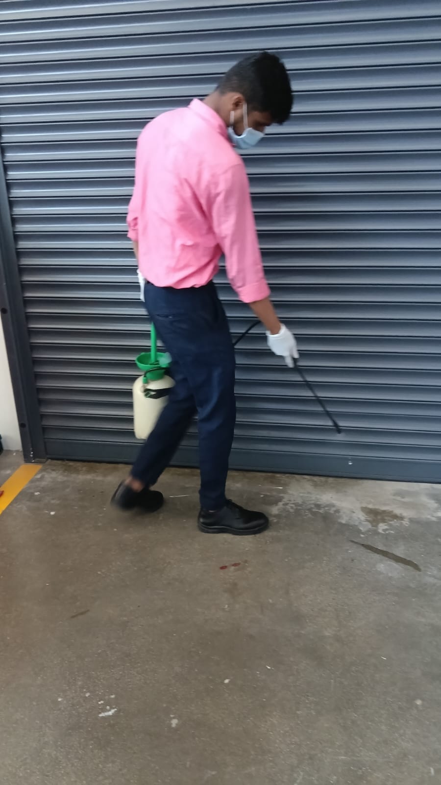 Star Link Pest Control technician treating the edge of a commercial premises