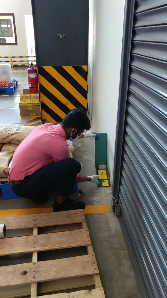 Star Link Pest Control technician checking a pest monitoring point at a commercial premises